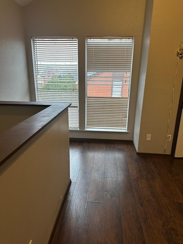 empty room featuring dark wood finished floors