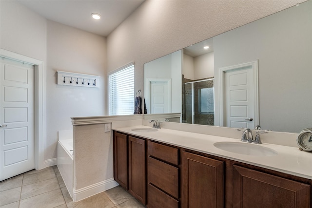 full bathroom featuring a stall shower, double vanity, a sink, and a garden tub