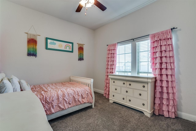 bedroom with baseboards, a ceiling fan, and dark carpet