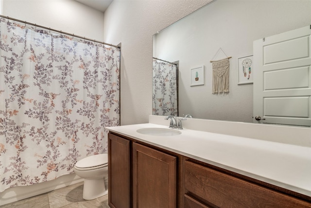 bathroom with toilet, tile patterned floors, and vanity