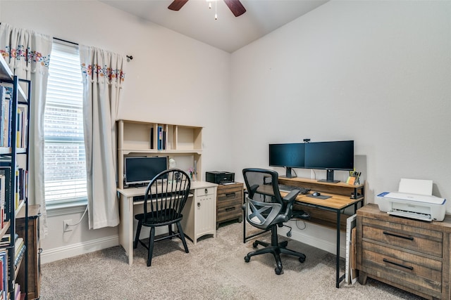 office area with ceiling fan, light carpet, baseboards, and plenty of natural light