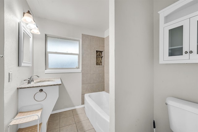 bathroom featuring tile patterned floors, toilet, washtub / shower combination, baseboards, and vanity