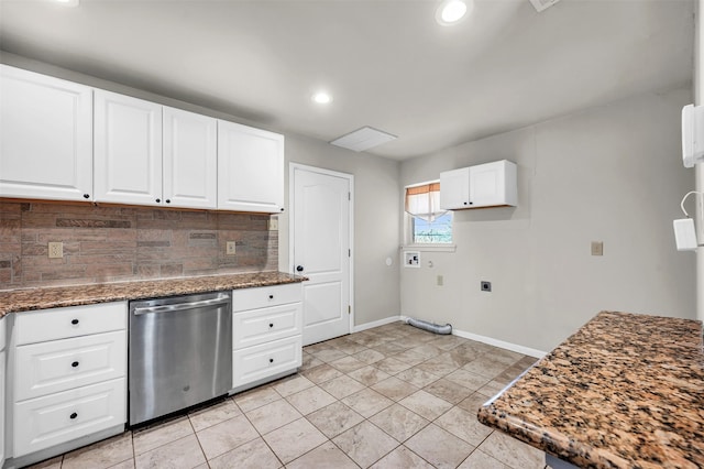 kitchen featuring dark stone countertops, stainless steel dishwasher, white cabinets, decorative backsplash, and baseboards