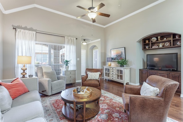 living room with arched walkways, ornamental molding, baseboards, and wood finished floors