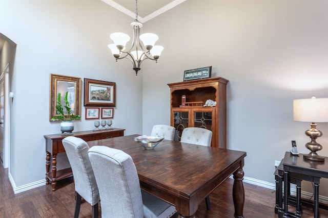 dining room with a notable chandelier, baseboards, dark wood-style flooring, and arched walkways