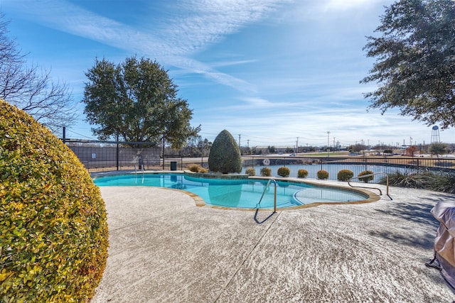 view of swimming pool featuring a patio area, a fenced in pool, and fence