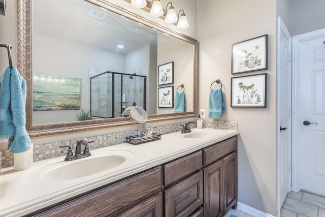 bathroom featuring a sink, visible vents, double vanity, and a shower stall