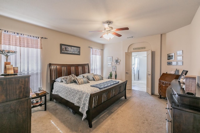 bedroom featuring visible vents, light colored carpet, and a ceiling fan