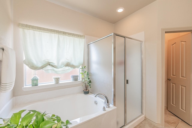 full bath with a stall shower, a bath, recessed lighting, and tile patterned flooring