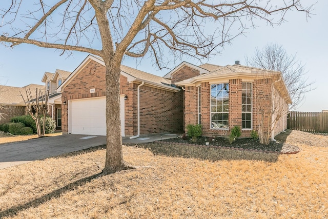 ranch-style house featuring brick siding, fence, roof with shingles, a garage, and driveway