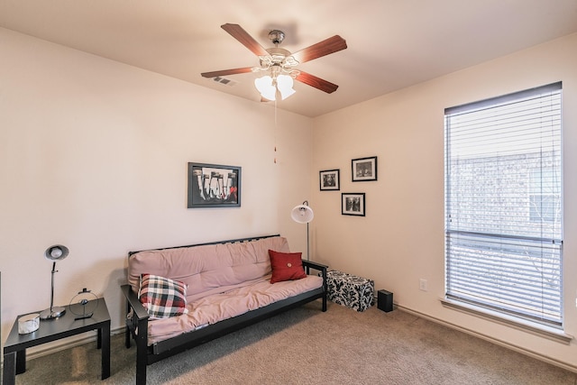 sitting room with carpet flooring, visible vents, and ceiling fan