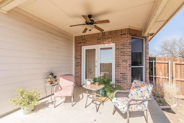 view of patio with ceiling fan and fence