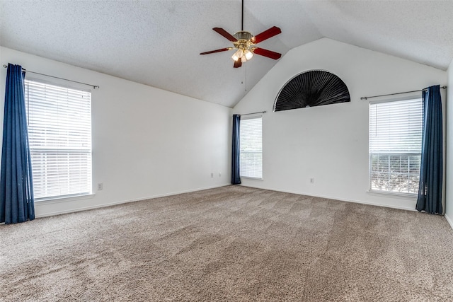 unfurnished room with carpet flooring, a textured ceiling, a ceiling fan, and vaulted ceiling