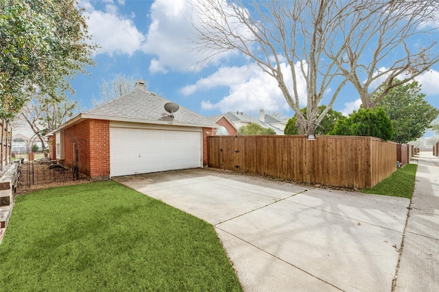 view of property exterior featuring brick siding, fence, a lawn, a chimney, and a garage