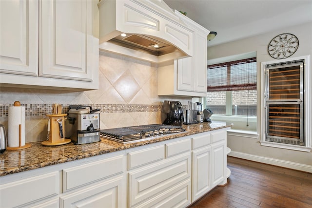 kitchen featuring backsplash, dark wood finished floors, custom range hood, stone countertops, and white cabinetry