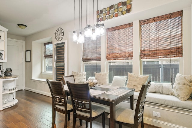 dining room featuring an inviting chandelier, dark wood-type flooring, and baseboards