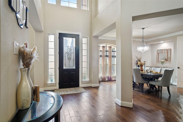 entryway featuring a wealth of natural light, crown molding, dark wood-type flooring, and baseboards