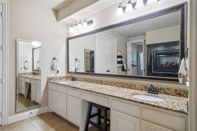 full bathroom with tile patterned flooring, double vanity, and a sink