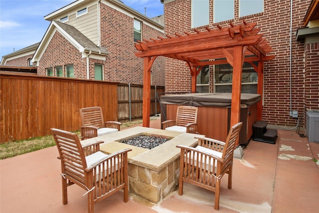 view of patio with an outdoor fire pit, a hot tub, a pergola, and fence