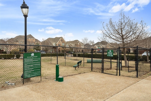 view of community featuring a gate, a residential view, and fence