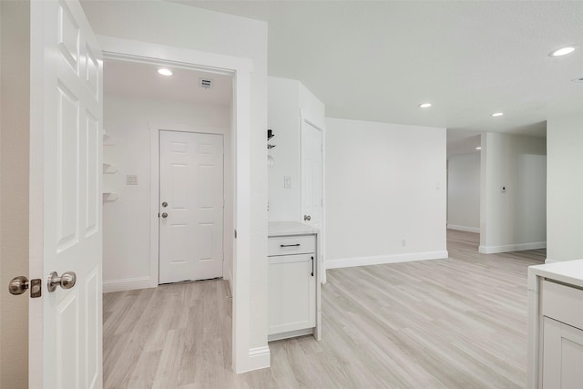 interior space featuring light wood finished floors, visible vents, recessed lighting, and baseboards