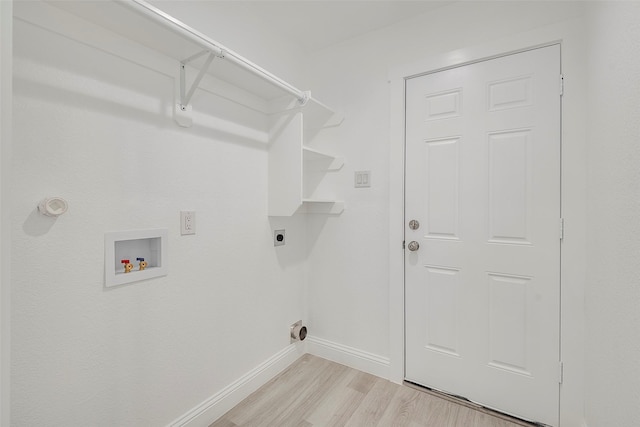 laundry area with hookup for a washing machine, baseboards, light wood finished floors, laundry area, and electric dryer hookup