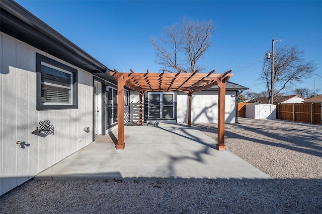 view of patio / terrace with a shed, fence private yard, a pergola, and an outdoor structure