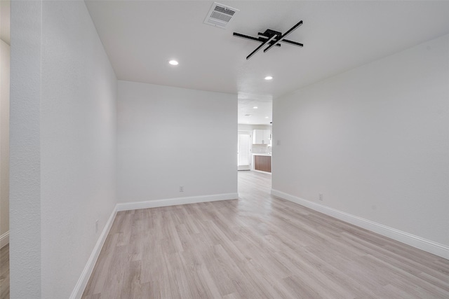 spare room featuring recessed lighting, baseboards, visible vents, and light wood-type flooring