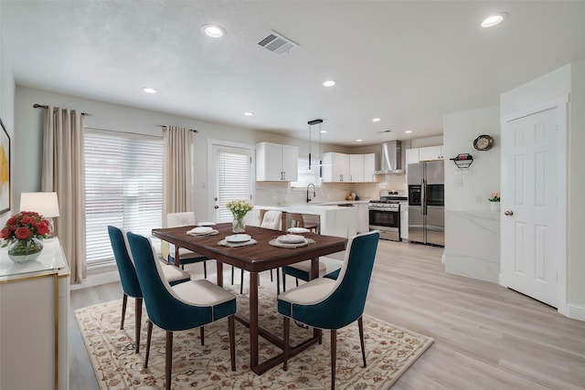 dining area with recessed lighting, visible vents, and light wood finished floors