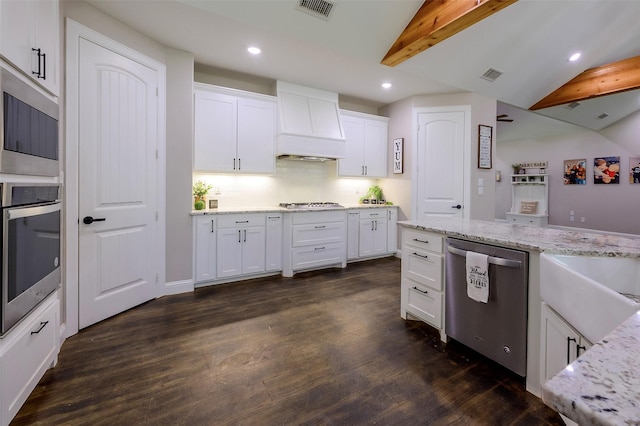 kitchen featuring visible vents, stainless steel appliances, lofted ceiling with beams, and custom range hood