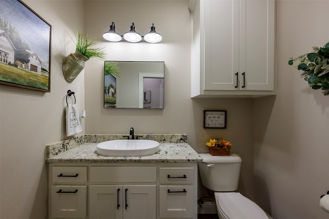 bathroom featuring toilet and vanity