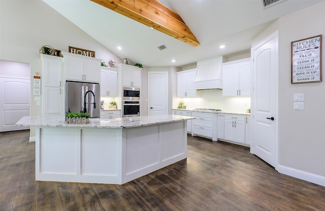 kitchen with white cabinetry, custom exhaust hood, a large island with sink, and stainless steel appliances