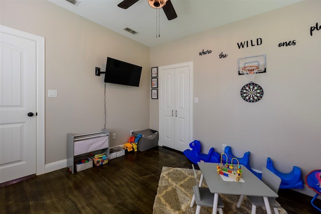 recreation room with baseboards, wood finished floors, visible vents, and ceiling fan