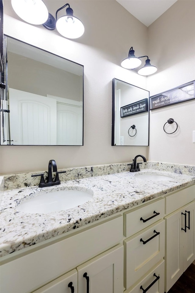 bathroom with a sink and double vanity