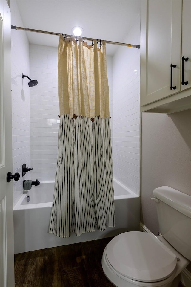 bathroom featuring toilet and shower / bath combo with shower curtain