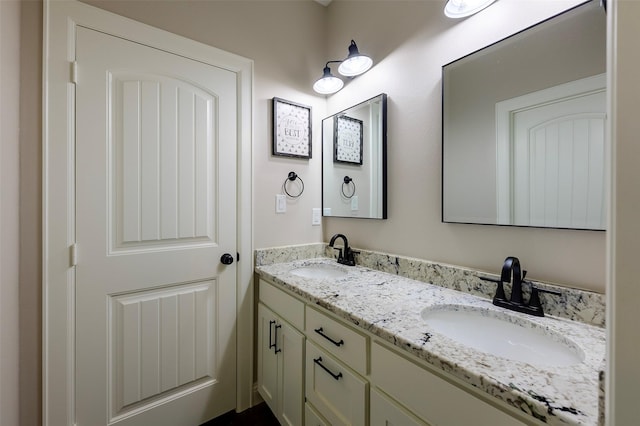 full bath with a sink and double vanity