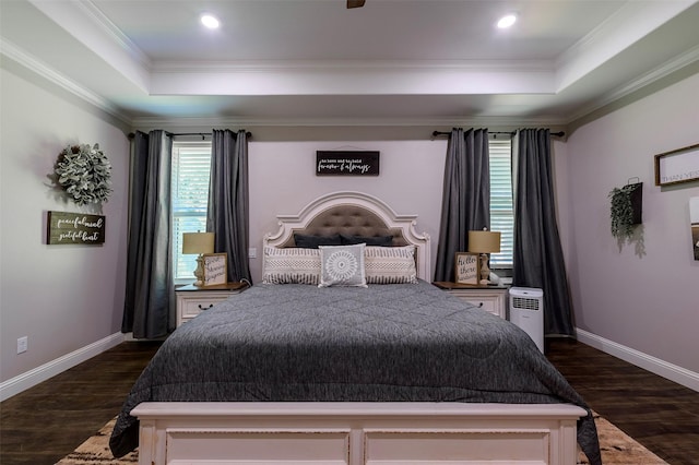 bedroom with baseboards, a raised ceiling, dark wood-style flooring, and crown molding