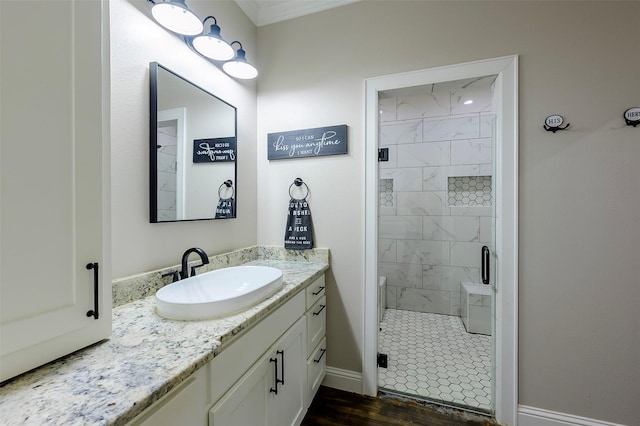 full bath featuring baseboards, a stall shower, and vanity