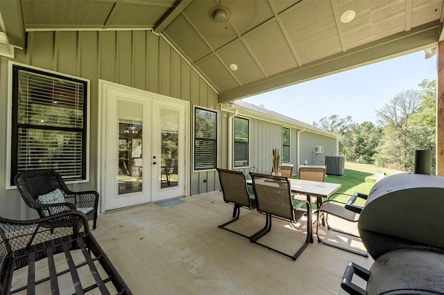 view of patio featuring grilling area, outdoor dining area, cooling unit, and french doors