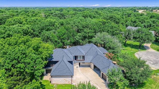 birds eye view of property with a forest view