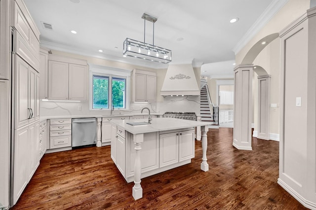 kitchen featuring visible vents, custom range hood, light countertops, dishwasher, and ornate columns