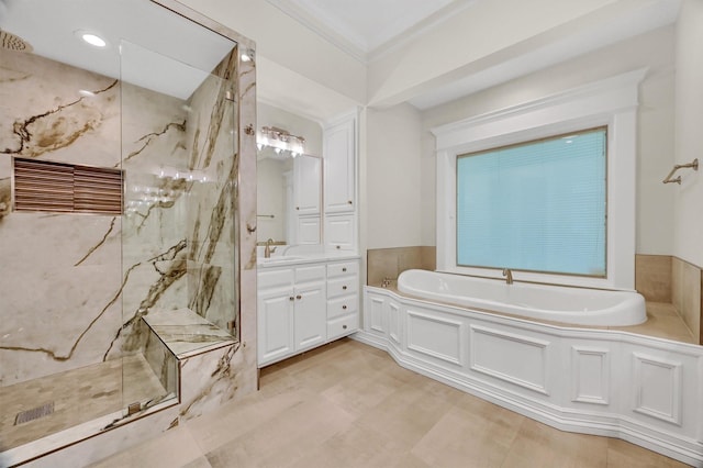 full bathroom with a marble finish shower, vanity, a garden tub, and ornamental molding