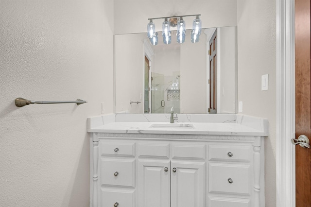 full bath with vanity and a shower stall