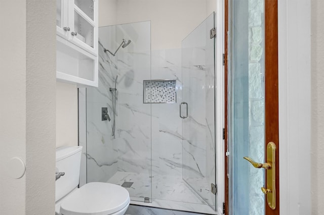 full bathroom with a marble finish shower and toilet