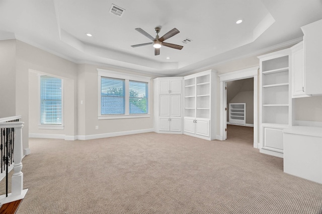 unfurnished bedroom featuring visible vents, light carpet, a raised ceiling, recessed lighting, and baseboards