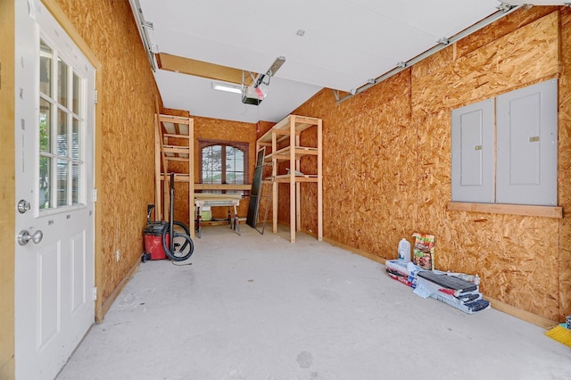 garage featuring electric panel and a garage door opener