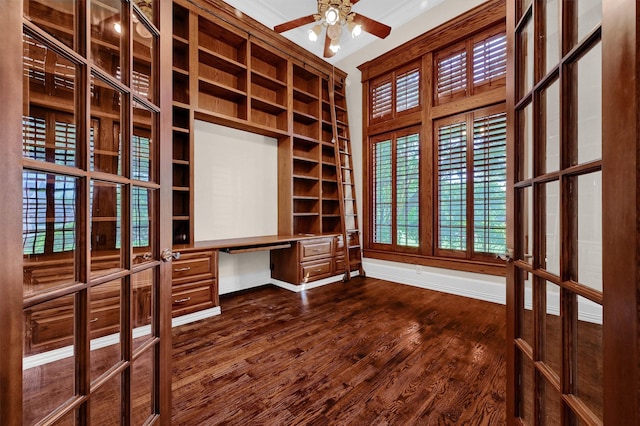 interior space featuring built in desk, ceiling fan, and dark wood-style flooring