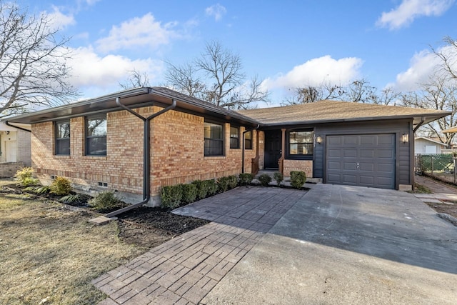 ranch-style house with a garage, brick siding, and driveway