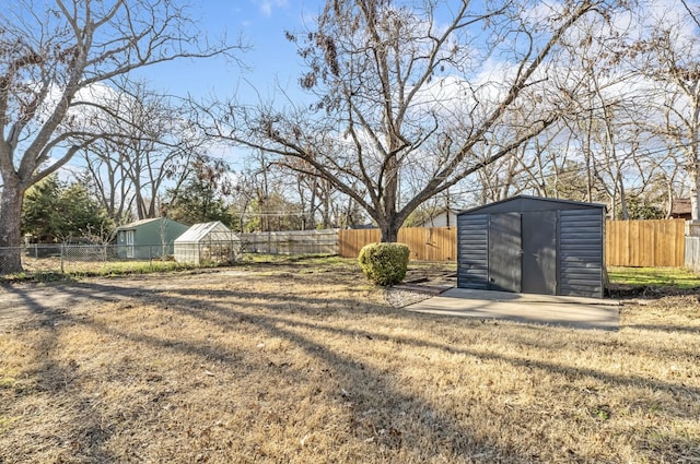 view of yard with a storage unit, a fenced backyard, and an outdoor structure