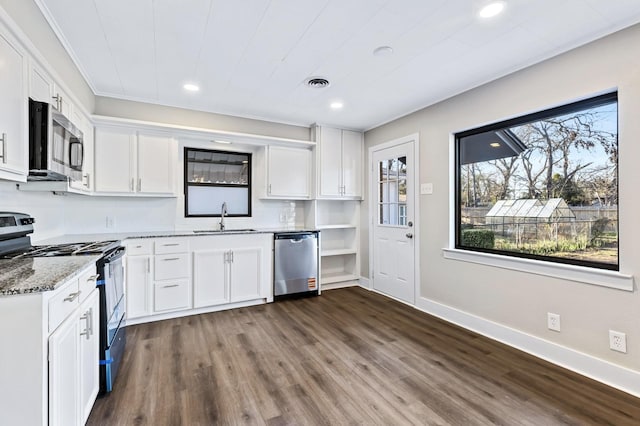 kitchen with visible vents, a sink, white cabinetry, stainless steel appliances, and light stone countertops